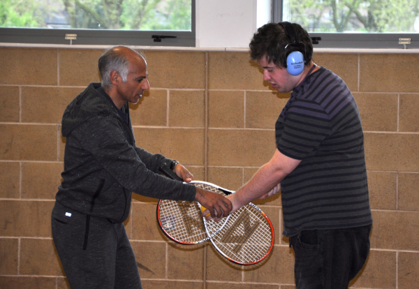 Two participants with tennis rackets