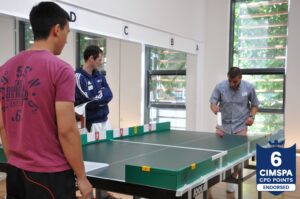 Participants playing table cricket